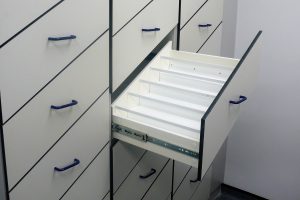Smart angled laboratory storage system with bespoke plastic stepped drawer inner