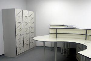 Smart laboratory storage system with angled drawer and and curved benching